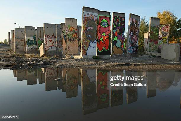 Former sections of the Berlin Wall are reflcted in a puddle on a sunny, fall day on October 11, 2008 in Teltow, just outside Berlin, Germany. Germany...