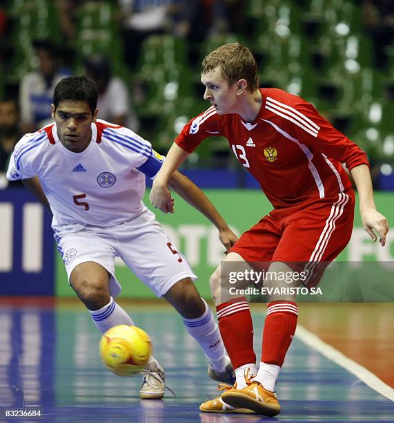 Russia's Konstantin Agopov is marked by Paraguay's Carlos Chilavert during a quarter-final match of the FIFA Futsal World Cup Brazil 2008, on October...