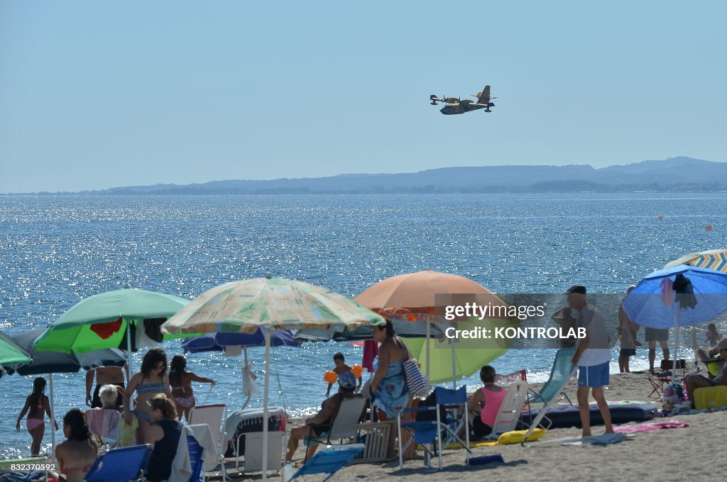 A Canadair fire fighting plane picks up water from the sea...