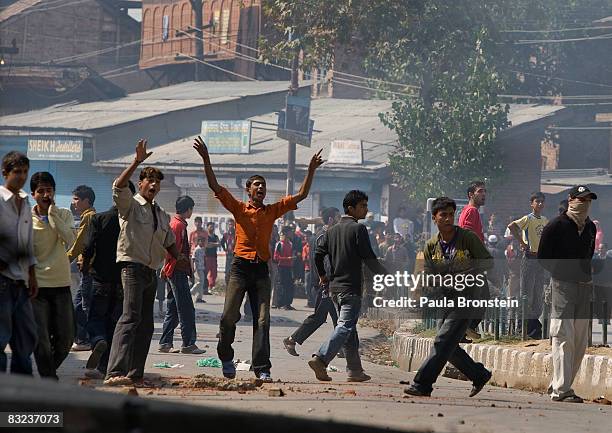 Kashmiri men throw rocks at Indian military while tensions on the streets remain high October 12, 2008 in Srinagar, Kashmir, India. Violence remains...