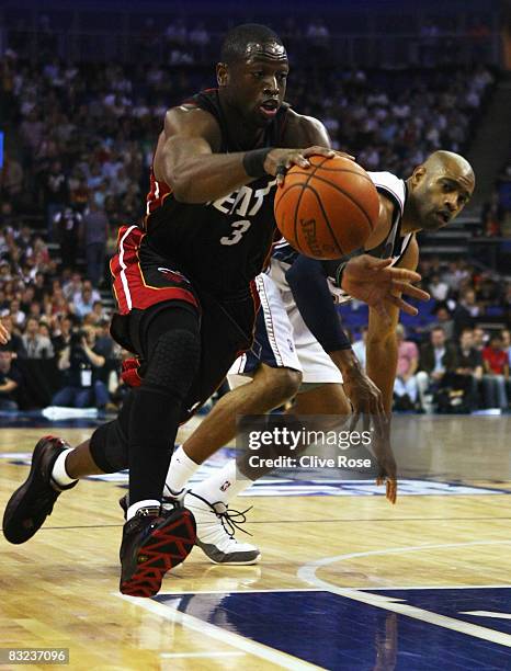 Dwyane Wade of Miami Heat drives past Vince Carter of the New Jersey Nets during the NBA preseason game as part of the 2008 NBA Europe Live Tour...