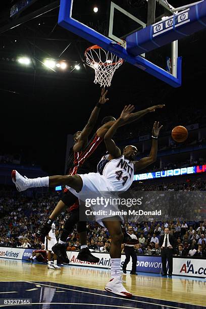 Trenton Hassell of New Jersey Nets is fouled by Udonis Haslem the Miami Heat during the NBA preseason game as part of the 2008 NBA Europe Live Tour...