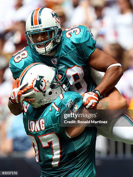 Running back Patrick Cobbs of the Miami Dolphins celebrates a touchdown with Jake Long against the Houston Texans in the first quarter at Reliant...