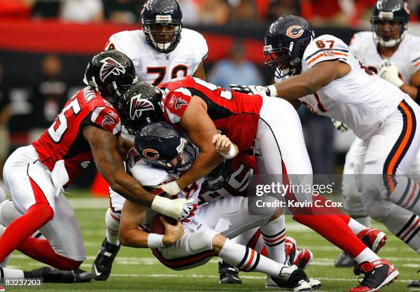 Quarterback Kyle Orton of the Chicago Bears is sacked by John Abraham and Jamaal Anderson of the Atlanta Falcons during the game at the Georgia Dome...