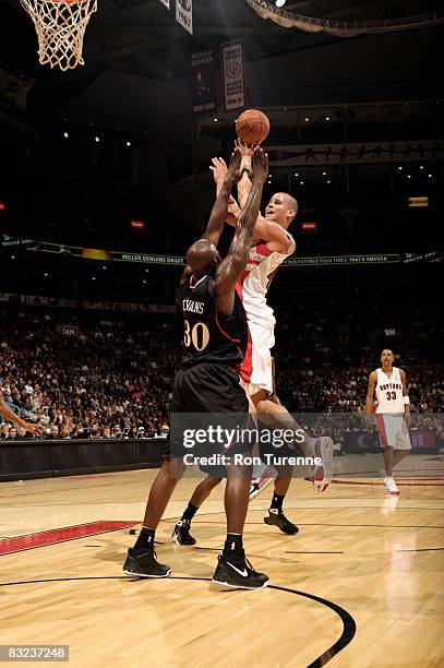 Kris Humphries of the Toronto Raptors takes a shot over Reggie Evans of the Philadelphia 76ers on October 12, 2008 at the Air Canada Centre in...