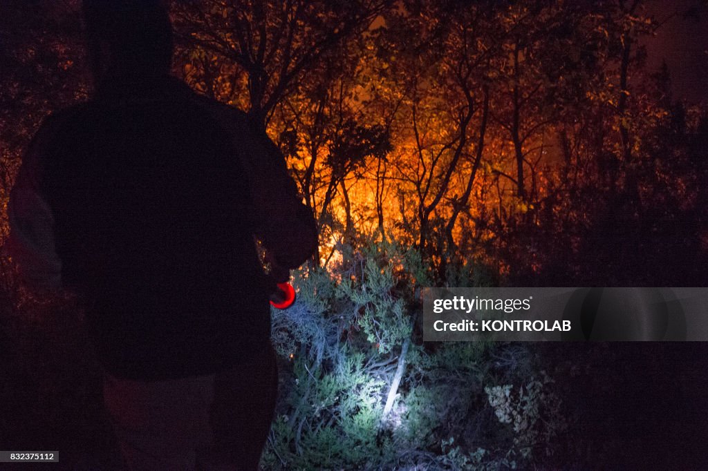 Volunteers and citizens work to extinguish a vast fire in...