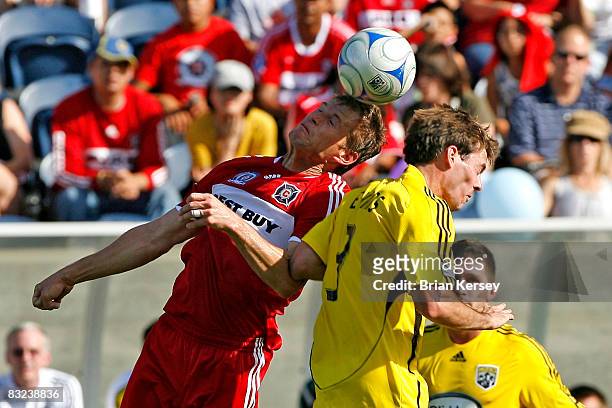 Brian McBride of the Chicago Fire and Brad Evans of the Columbus Crew go up for a header during the first half at Toyota Park on October 12, 2008 in...
