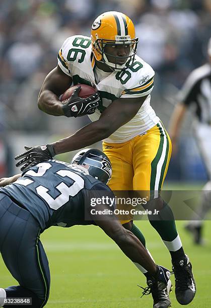 Tight end Donald Lee of the Green Bay Packers rushes against Marcus Trufant of the Seattle Seahawks on October 12, 2008 at Qwest Field in Seattle,...