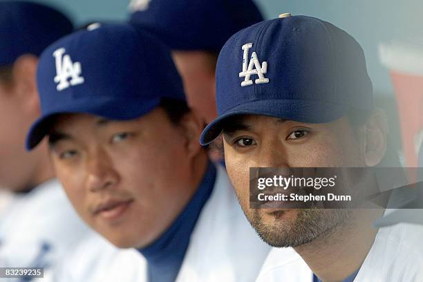 Hong-Chih Kuo and Chan Ho Park of the Los Angeles Dodgers look on from the dugout during Game Three of the National League Championship Series...