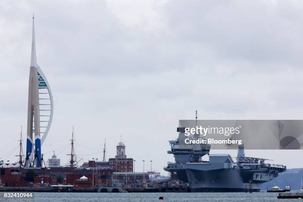 The U.K.'s Royal Navy new aircraft carrier, HMS Queen Elizabeth, sits docked at its home port in Portsmouth, U.K., on Wednesday, Aug. 16, 2017. The...