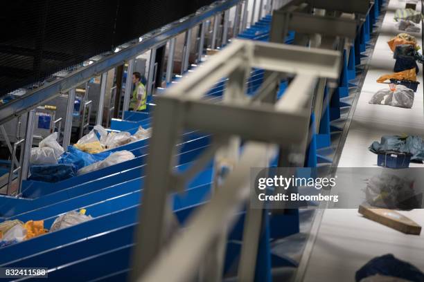 Packages sit in mail chutes and pass along a conveyor inside the KLM Cargo center, operated by Air France-KLM Group, at Schiphol airport in...