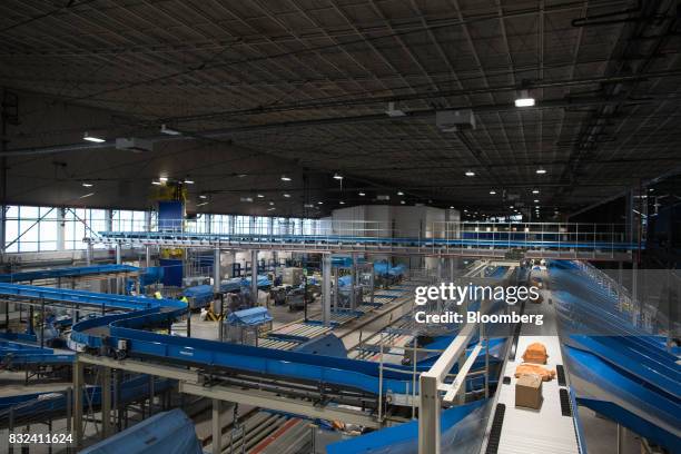 Packages pass along conveyors inside the KLM Cargo center, operated by Air France-KLM Group, at Schiphol airport in Amsterdam, Netherlands, on...