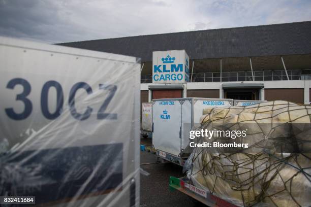 Shipping crates stand outside the KLM Cargo center, operated by Air France-KLM Group, at Schiphol airport in Amsterdam, Netherlands, on Tuesday, Aug....