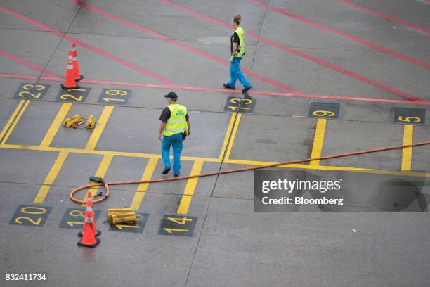 Ground crew await the arrival of a passenger aircraft operated by KLM, the Dutch arm of Air France-KLM Group, at Schiphol airport in Amsterdam,...