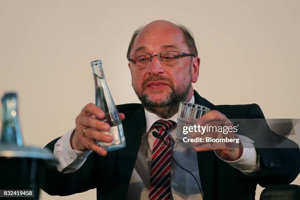 Martin Schulz, Social Democrat Party candidate for German Chancellor, prepares to pour a drink of water during a panel discussion after delivering a...