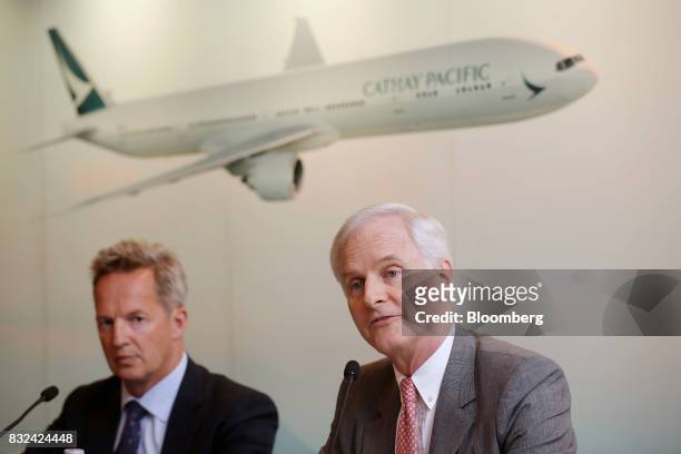 John Slosar, chairman of Cathay Pacific Airways Ltd., right, speaks as Rupert Hogg, chief executive officer, looks on during a news conference in...