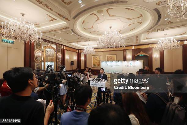 Paul Loo, chief customer and commercial officer of Cathay Pacific Airways Ltd., center, speaks to members of the media following a news conference in...