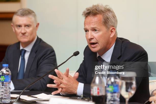 Rupert Hogg, chief executive officer of Cathay Pacific Airways Ltd., right, speaks during a news conference in Hong Kong, China, on Wednesday, Aug....