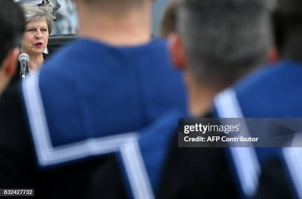 Britain's Prime Minister Theresa May stands on the flight deck as she speaks to crew members of the 65,000-tonne British aircraft carrier HMS Queen...