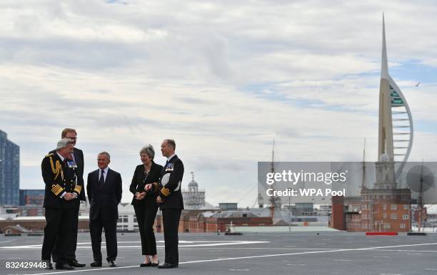 Britain's Prime Minister Theresa May talks with Commodore Jerry Kyd , Captain of the 65,000-tonne British aircraft carrier HMS Queen Elizabeth after...