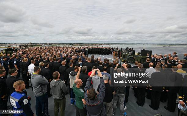 Britain's Prime Minister Theresa May stands on the flight deck and speaks to crew members of the 65,000-tonne British aircraft carrier HMS Queen...