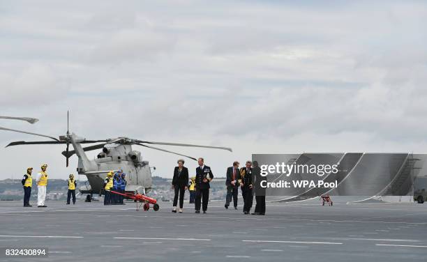 Britain's Prime Minister Theresa May talks with Commodore Jerry Kyd , Captain of the 65,000-tonne British aircraft carrier HMS Queen Elizabeth after...