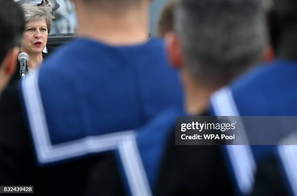 Britain's Prime Minister Theresa May stands on the flight deck and speaks to crew members of the 65,000-tonne British aircraft carrier HMS Queen...