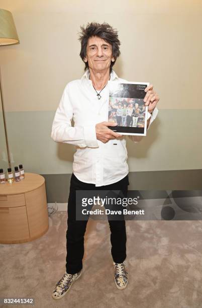Ronnie Wood holds a copy of his new book 'Ronnie Wood: Artist' at Selfridges on August 15, 2017 in London, England.