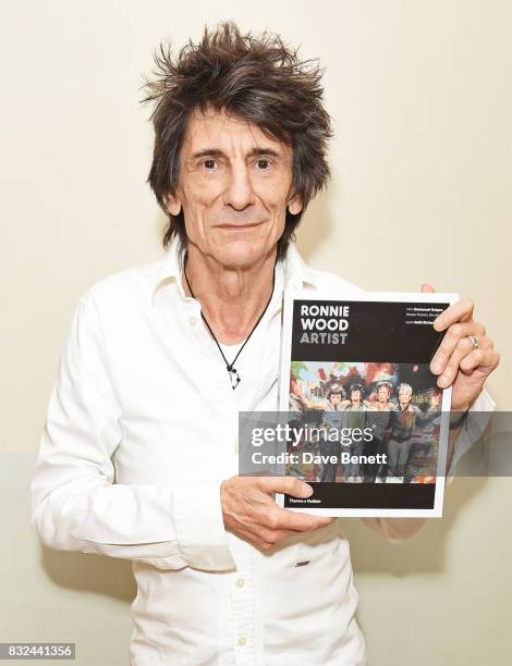 Ronnie Wood holds a copy of his new book 'Ronnie Wood: Artist' at Selfridges on August 15, 2017 in London, England.