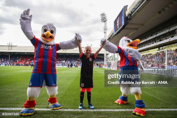 Crystal Palace mascots with a young Huddersfield Town Mascot during the Premier League match between Crystal Palace and Huddersfield Town at Selhurst...
