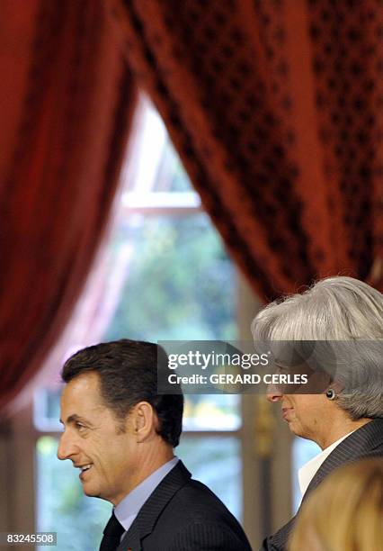 French President Nicolas Sarkozy , flanked by French Economy Minister Christine Lagarde, is pictured at the end of his statement following a special...