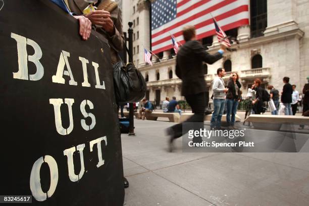 People protest outside of the New York Stock Exchange October 13, 2008 in New York City. Following a rise in global markets, the Dow was up over 400...