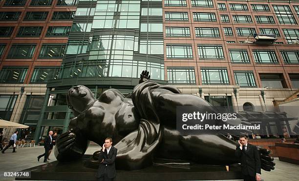 City workers stand by a sculpture of a reclining Venus figure by Fernando Botero in Exchange Square on October 13, 2008 in London. The UK Government...