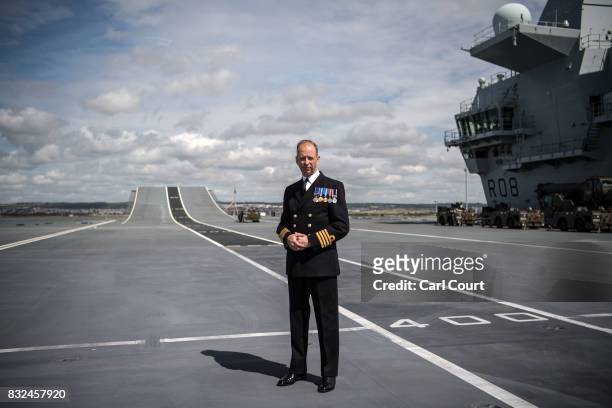 Commodore Jerry Kyd, the captain of HMS Queen Elizabeth, poses for a photograph on the flight deck shortly after the ship's arrival in Portsmouth...