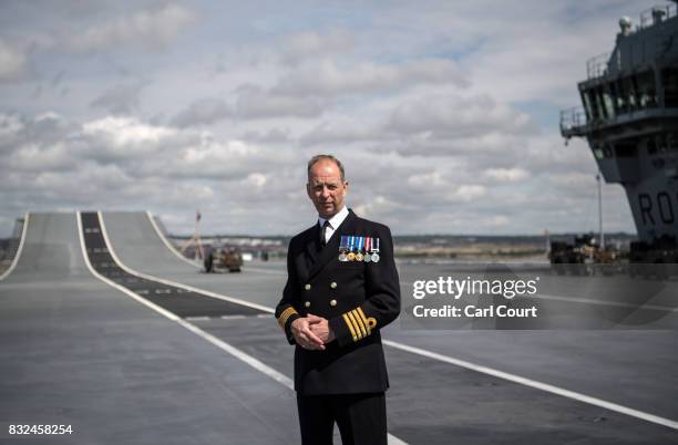 Commodore Jerry Kyd, the captain of HMS Queen Elizabeth, poses for a photograph on the flight deck shortly after the ship's arrival in Portsmouth...