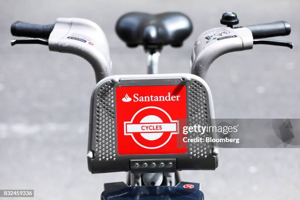 Bicycles, available to hire, stands in the street with the logo of sponsor Banco Santander SA, in London, U.K., on Tuesday, Aug. 15, 2017. Banco...