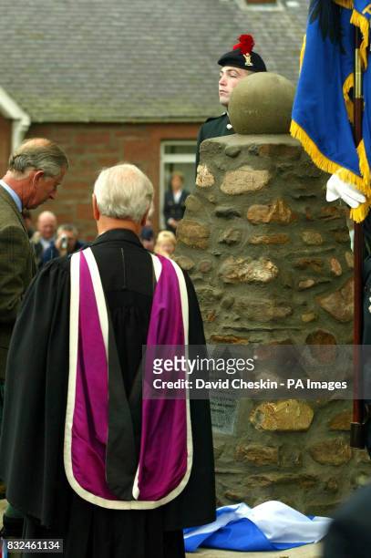 The Prince of Wales looks at a memorial cairn dedicated to the last veteran of the First World War's Christmas truce Alfred Anderson, who died in...