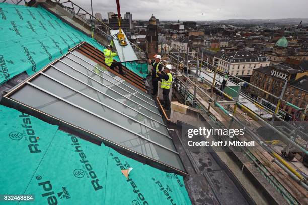 Workmen place glass windows into the iconic Japanese inspired studio 58 in Glasgow School of Art which is located two floor above the library in the...