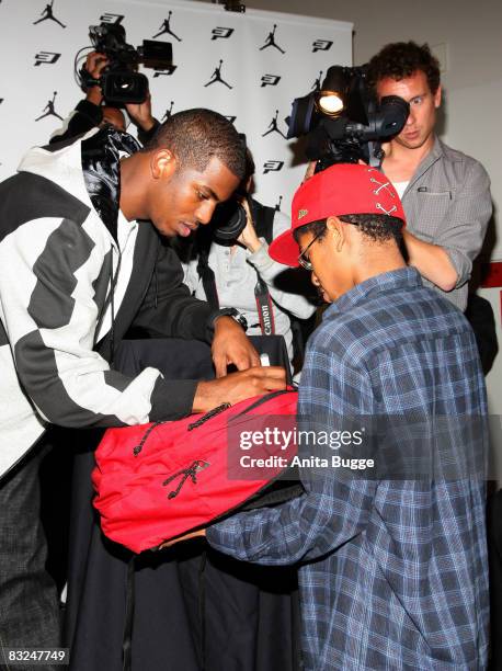 Player New Orleans Hornets point guard Chris Paul signs autographs during an instore appearance at the Niketown store on October 13, 2008 in Berlin,...