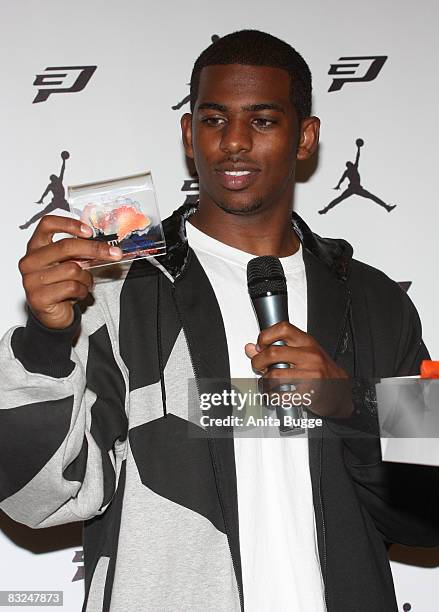 Player New Orleans Hornets point guard Chris Paul receives a little piece of the Berlin wall during an instore appearance at the Niketown store on...