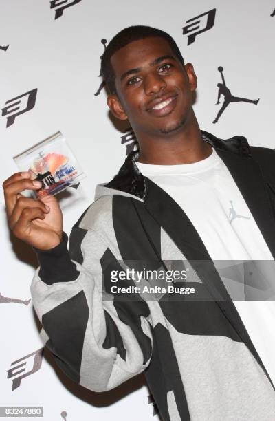 Player New Orleans Hornets point guard Chris Paul receives a little piece of the Berlin wall during an instore appearance at the Niketown store on...