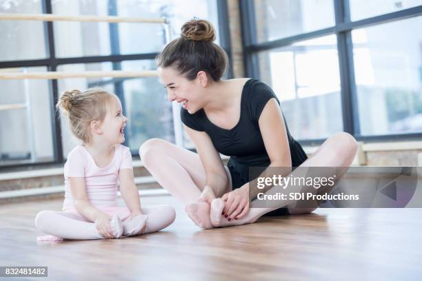 young ballet instructor laughs with preschool age student - nylon stock pictures, royalty-free photos & images