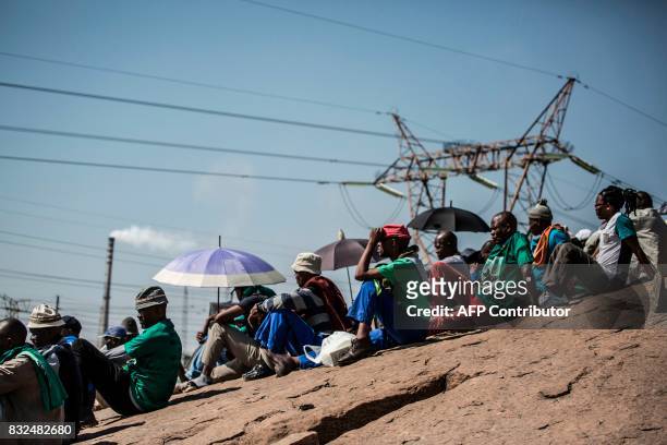 Members of the Association of Mineworkers and the Marikana community sit on the hill side as they gather to commemorate the fifth anniversary of the...