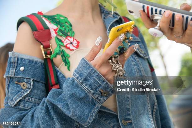 Tv presenter and DJ Yuri wears a Pinko dress, Uniqlo jacket and Gucci bag and sparkly nails day 2 of Paris Haute Couture Fashion Week Autumn/Winter...