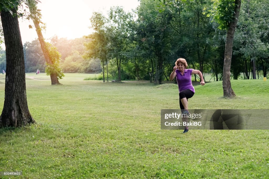 Senior woman exercising in the park