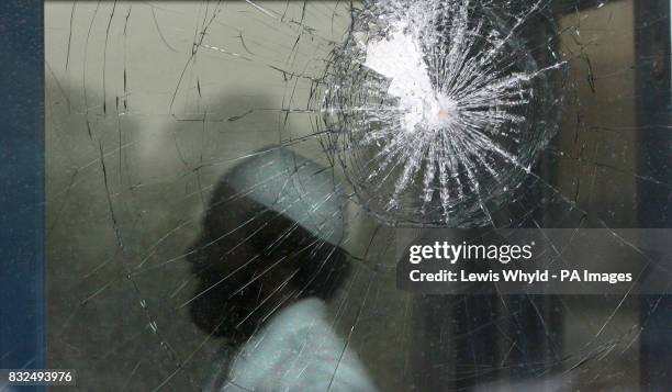 Muslim enters Technor House, past a vandalised window, which is being used as a Mosque by local Muslims next to the Medina Dairy in Windsor,...