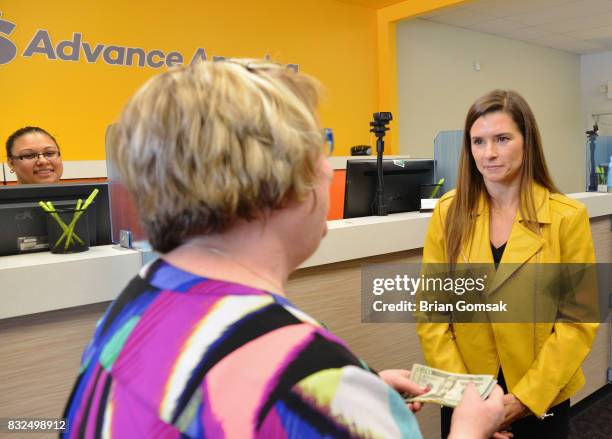 Professional Race Car Driver and Advance America Brand Ambassador Danica Patrick surprises customer Janice Walker by paying her bill in celebration...