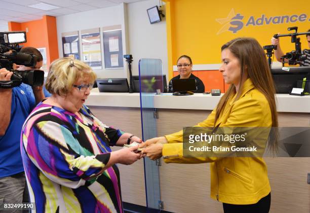 Professional Race Car Driver and Advance America Brand Ambassador Danica Patrick surprises customer Janice Walker by paying her bill in celebration...