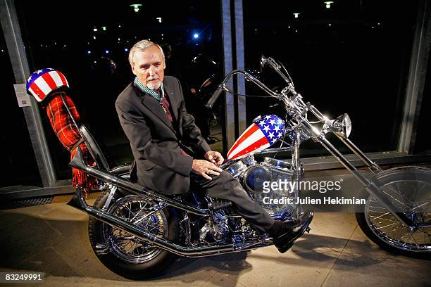 Dennis Hopper poses on the Harley Davidson he rode in the film Easy Rider, after he receives the French order des Arts et des Lettres during the...
