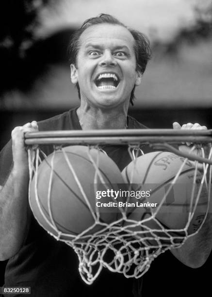 Closeup portrait of celebrity actor and Los Angeles Lakers fan Jack Nicholson dunking ball into net. CREDIT: Brian Lanker